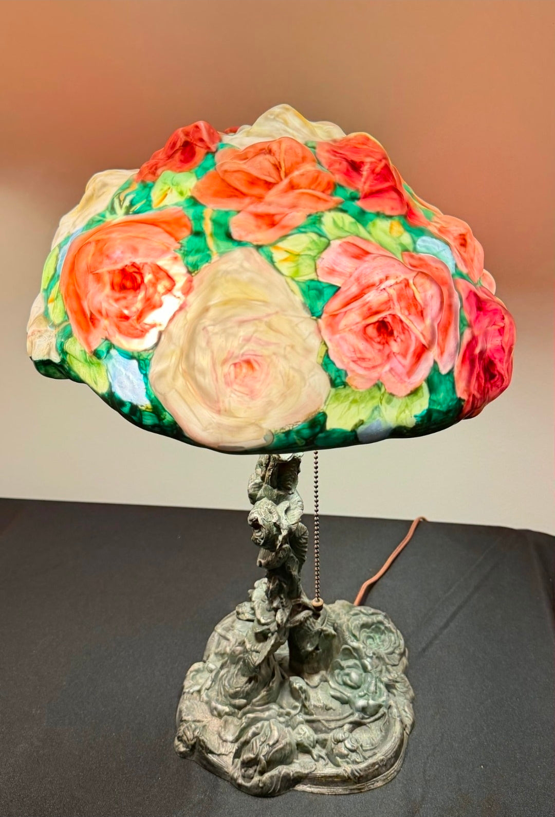 Decorative lamp with a colorful floral shade on a plain background