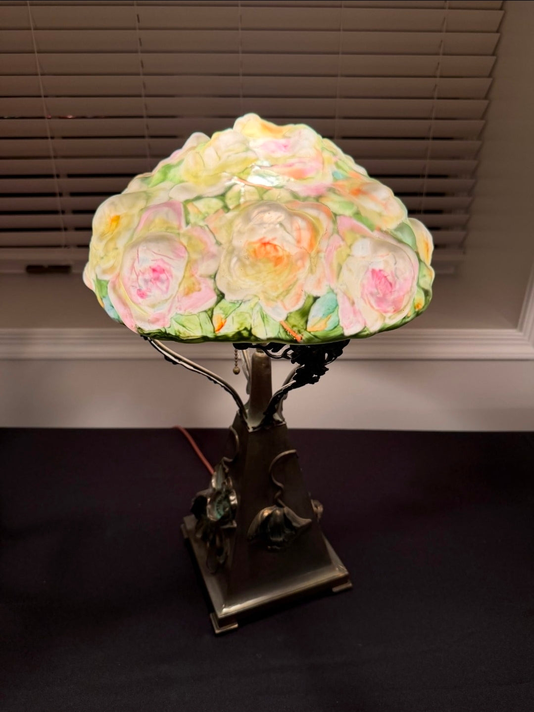 Decorative lamp with floral design on a dark surface